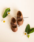 Adelisa & Co Sol Oxford style Mary Janes with sun details in medium brown leather. These vintage style Mary Jane leather shoes for girls feature a subtle design that pairs well with any outfit.