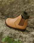 Chelsea style leather boot for children in cognac leather. This slip on boot features an elastic side and flexible soles.