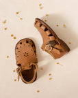 Adelisa & Co medium brown leather sandals for girls with floral detailing.