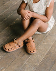 Adelisa & Co medium brown leather sandals for girls with floral detailing.