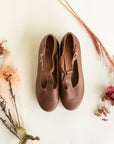 Dark brown leather Mary Jane shoes for women with floral detailing.