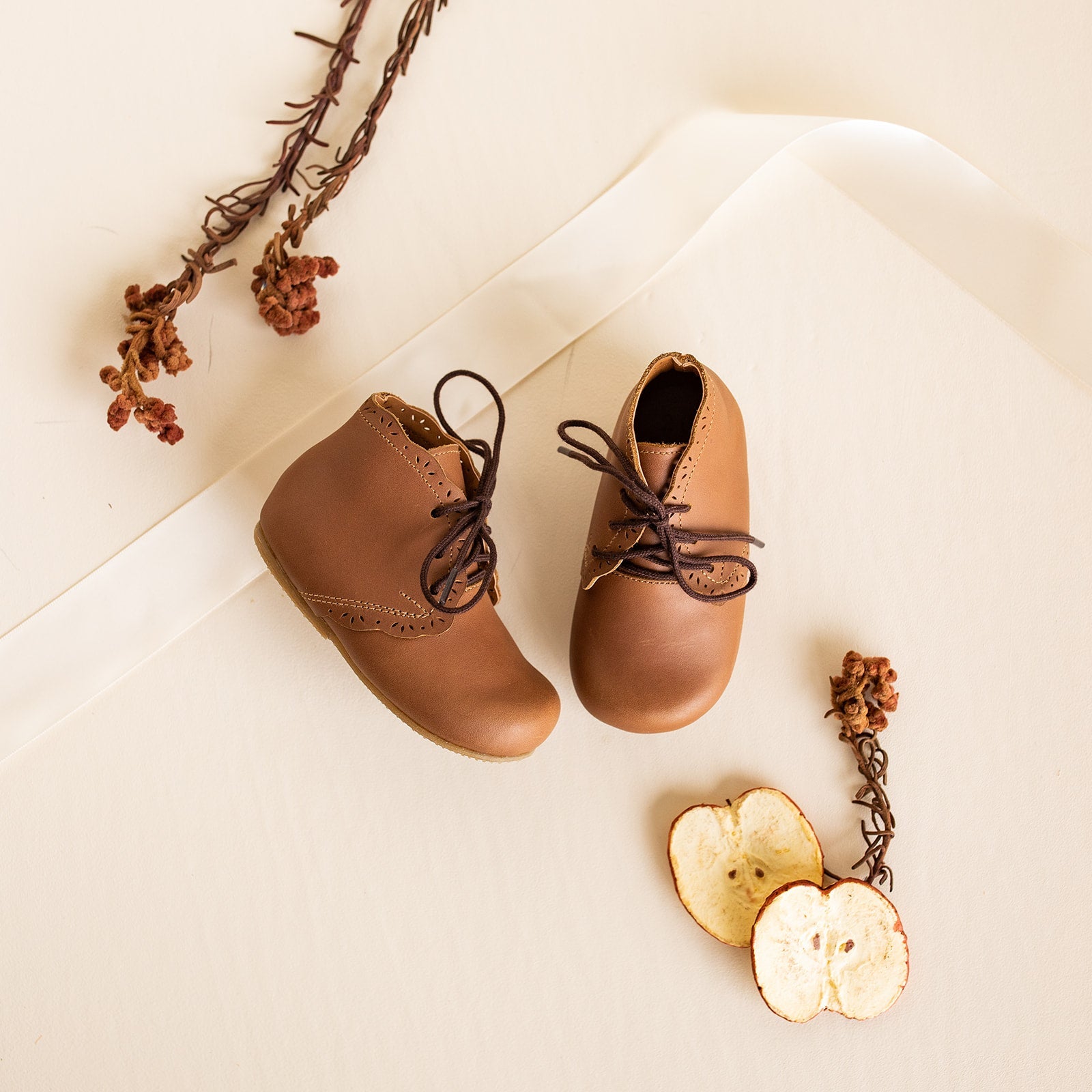 Adelisa &amp; Co handmade leather Primavera boots in a medium brown tone. These leather children&#39;s boots feature beautiful scallop edging and subtle floral details.