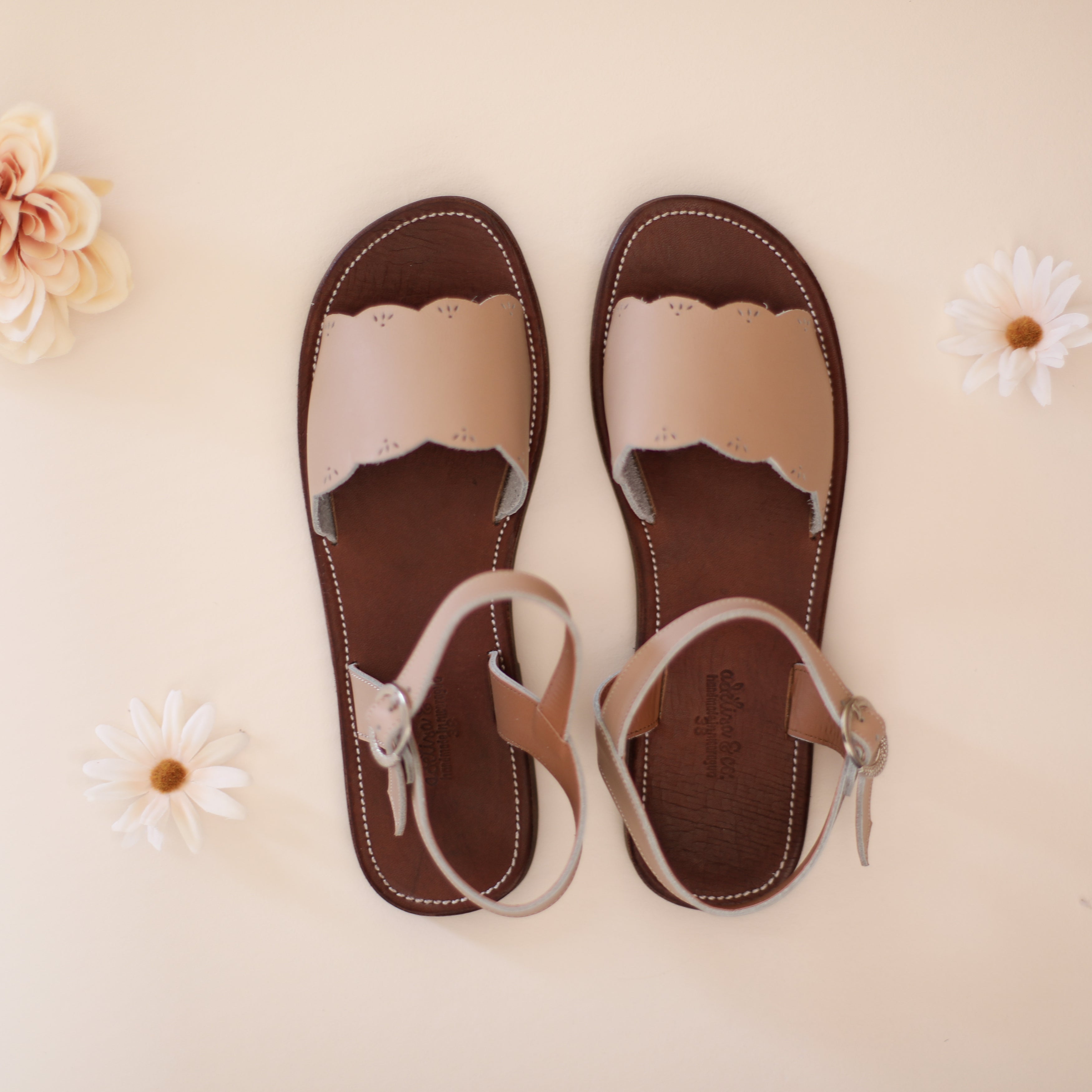 Adelisa &amp; Co nude blush pink leather sandals for women with scallop and floral detailing.
