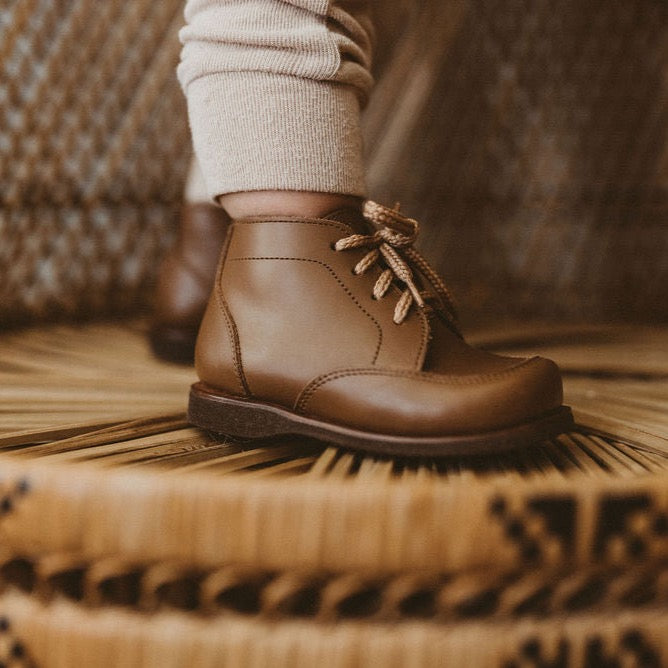 Adelisa &amp; Co. Vintage style leather boots for children. Our Antigua leather boots come in a medium brown leather and feature a simplistic design with a round toe.