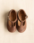 Soft sole Catarina Mary Janes for babies made with dark brown leather featuring floral detailing.