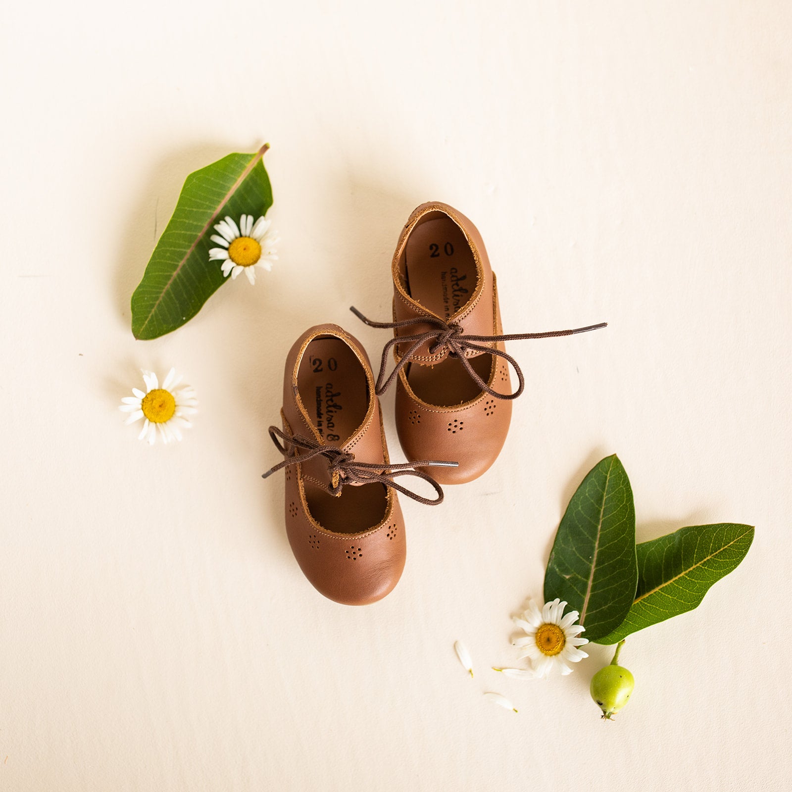 Adelisa &amp; Co Sol Oxford style Mary Janes with sun details  in medium brown leather. These vintage style Mary Jane leather shoes for girls feature a subtle design that pairs well with any outfit.