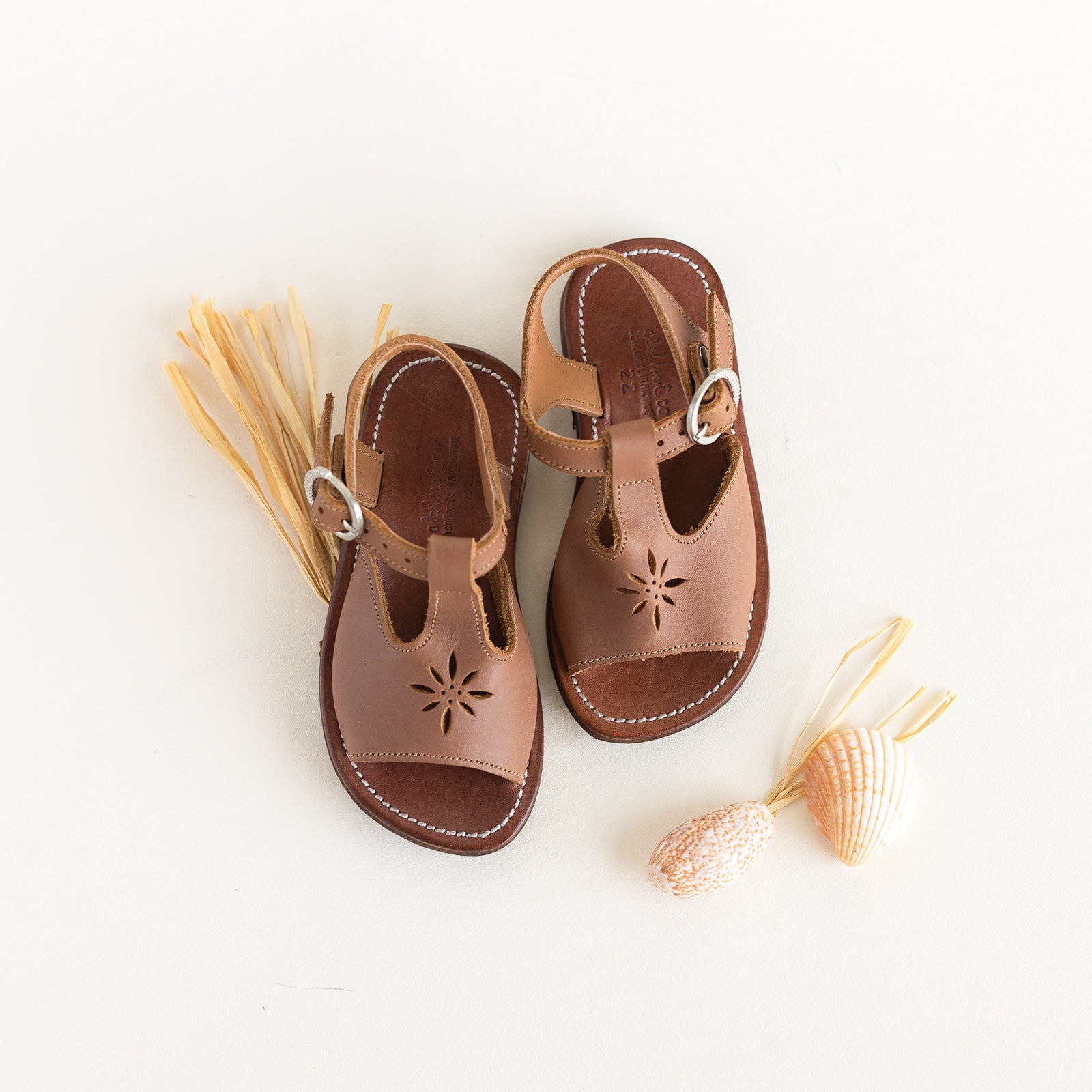 Adelisa & Co T-bar leather sandals for girls with floral detailing.