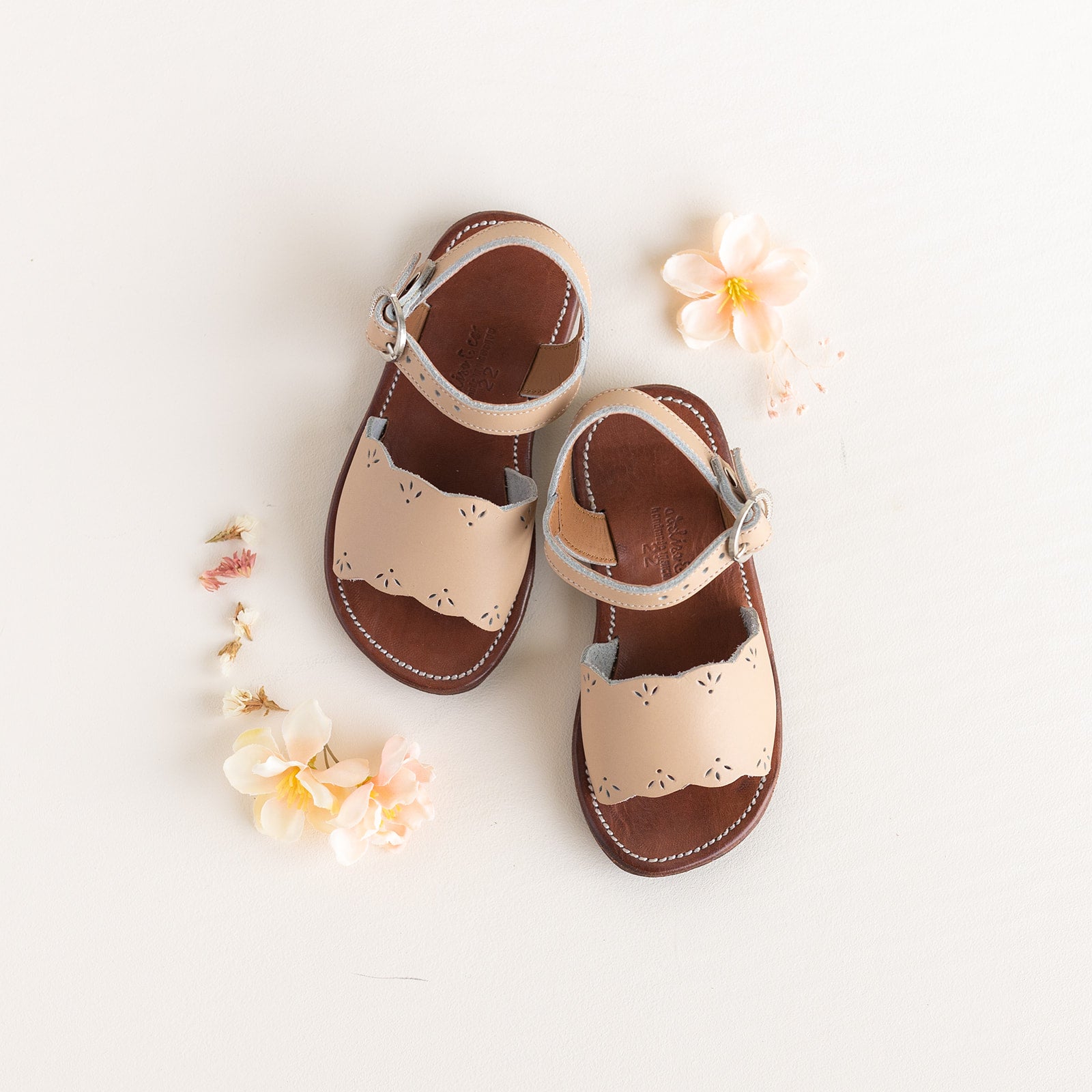 Adelisa &amp; Co nude blush pink leather girl&#39;s sandals with scallop and floral detailing.