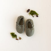 Baby soft sole, loafer style, slip on shoe with elastic sides. This moccasin style baby shoe comes in a dark, earthy green leather.