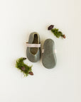 Baby soft sole, slip on Mary Jane with elastic band. This Mary Jane baby shoe comes in a dark, earthy green leather.