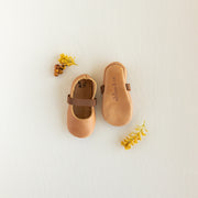 Slip on, soft sole baby Mary Jane with elastic band in a cognac leather.