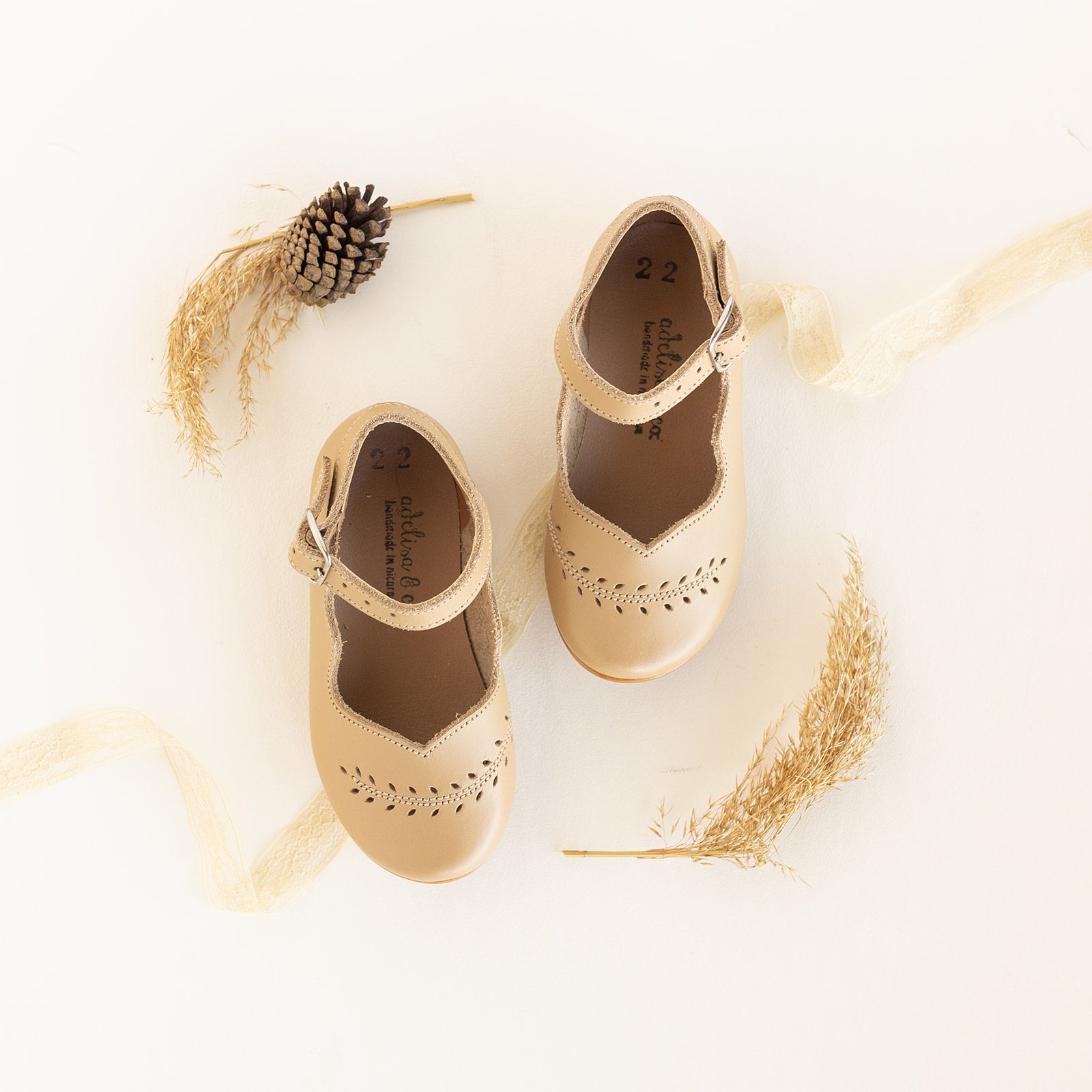 Handmade Mary Jane leather shoes for girls with leaf detail. These leather shoes come in a beautiful beige leather color.