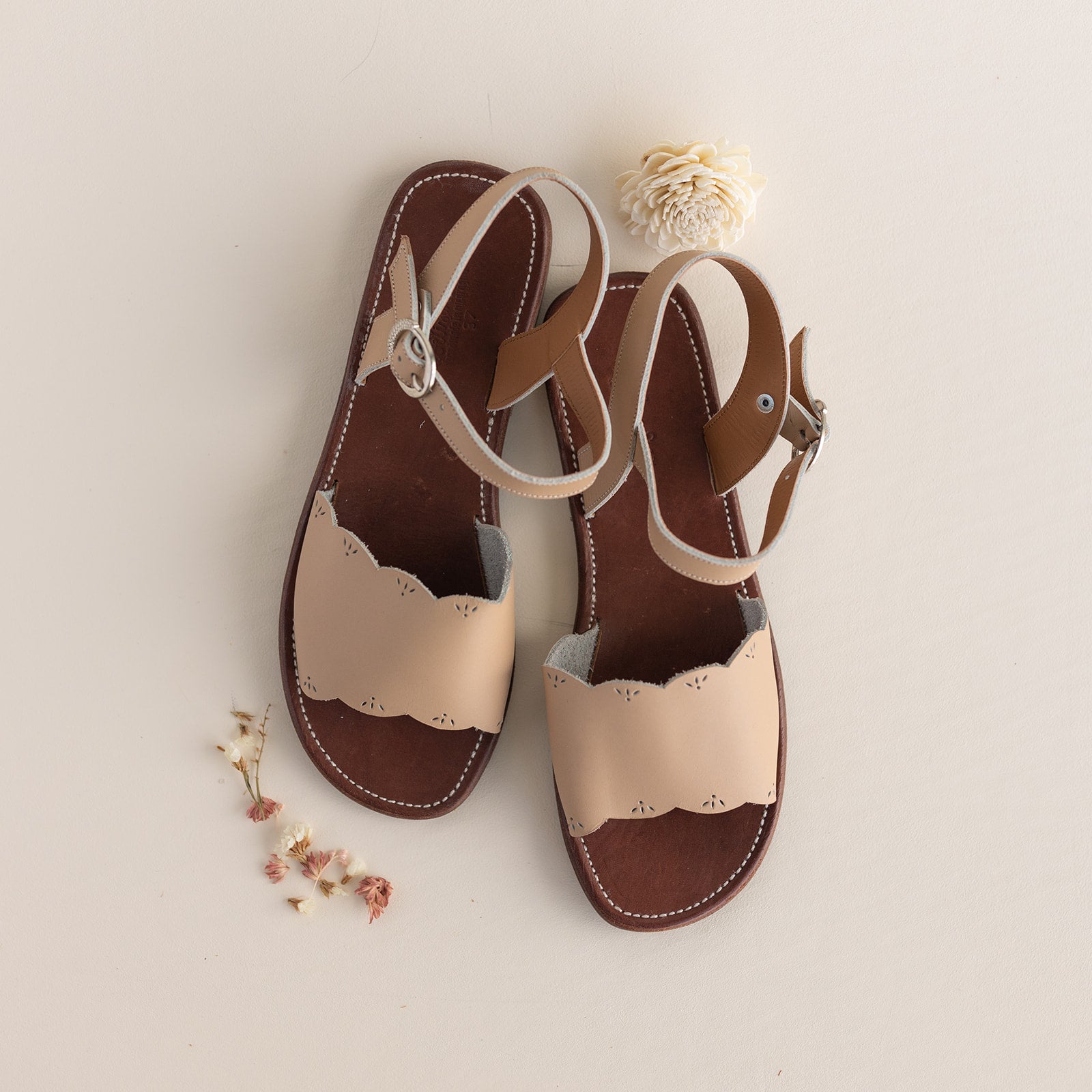 Adelisa & Co nude blush pink leather sandals for women with scallop and floral detailing.