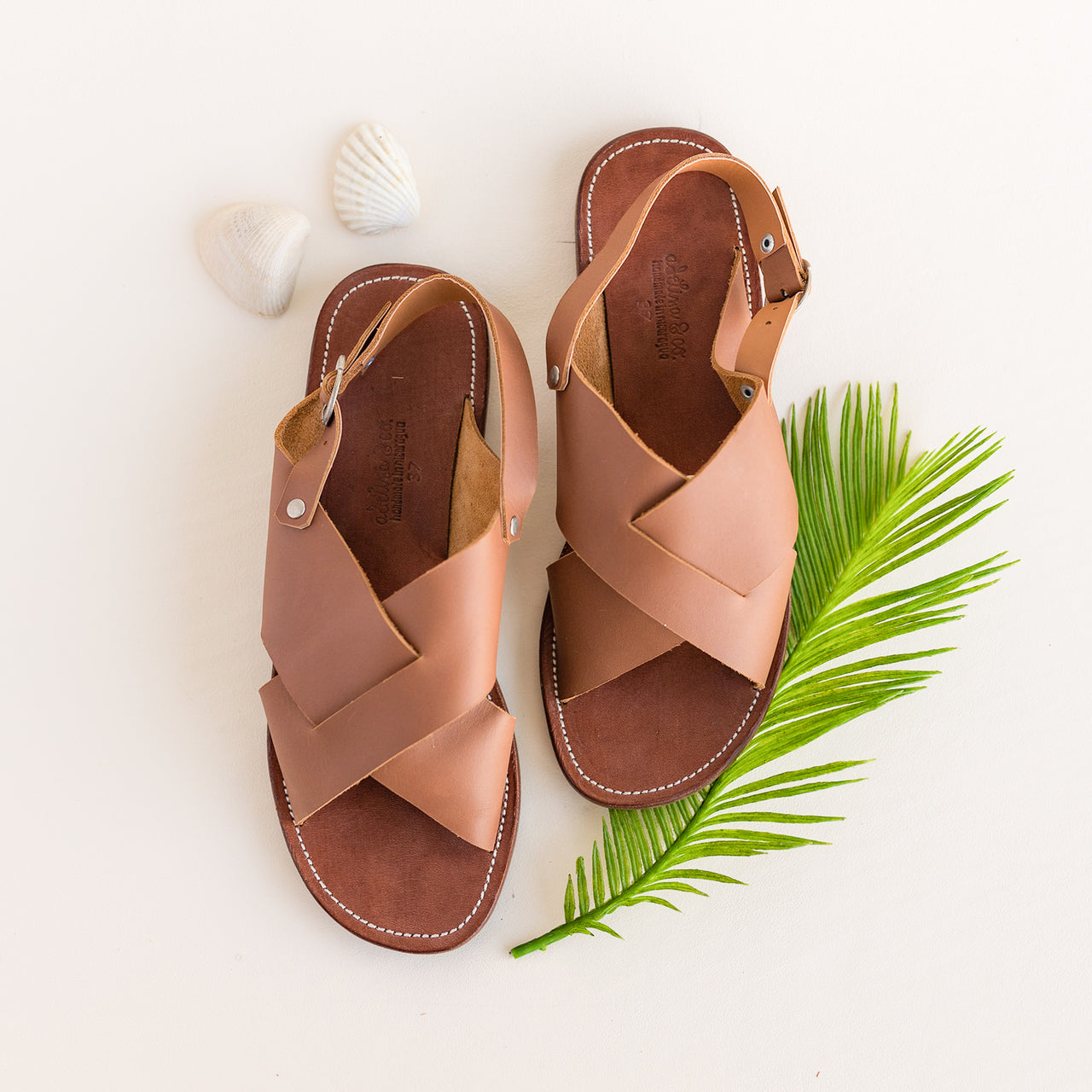Cross strap, medium brown leather sandals for women.