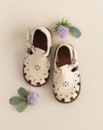 Closed toe, vintage style cream leather sandals for girls with floral detailing.