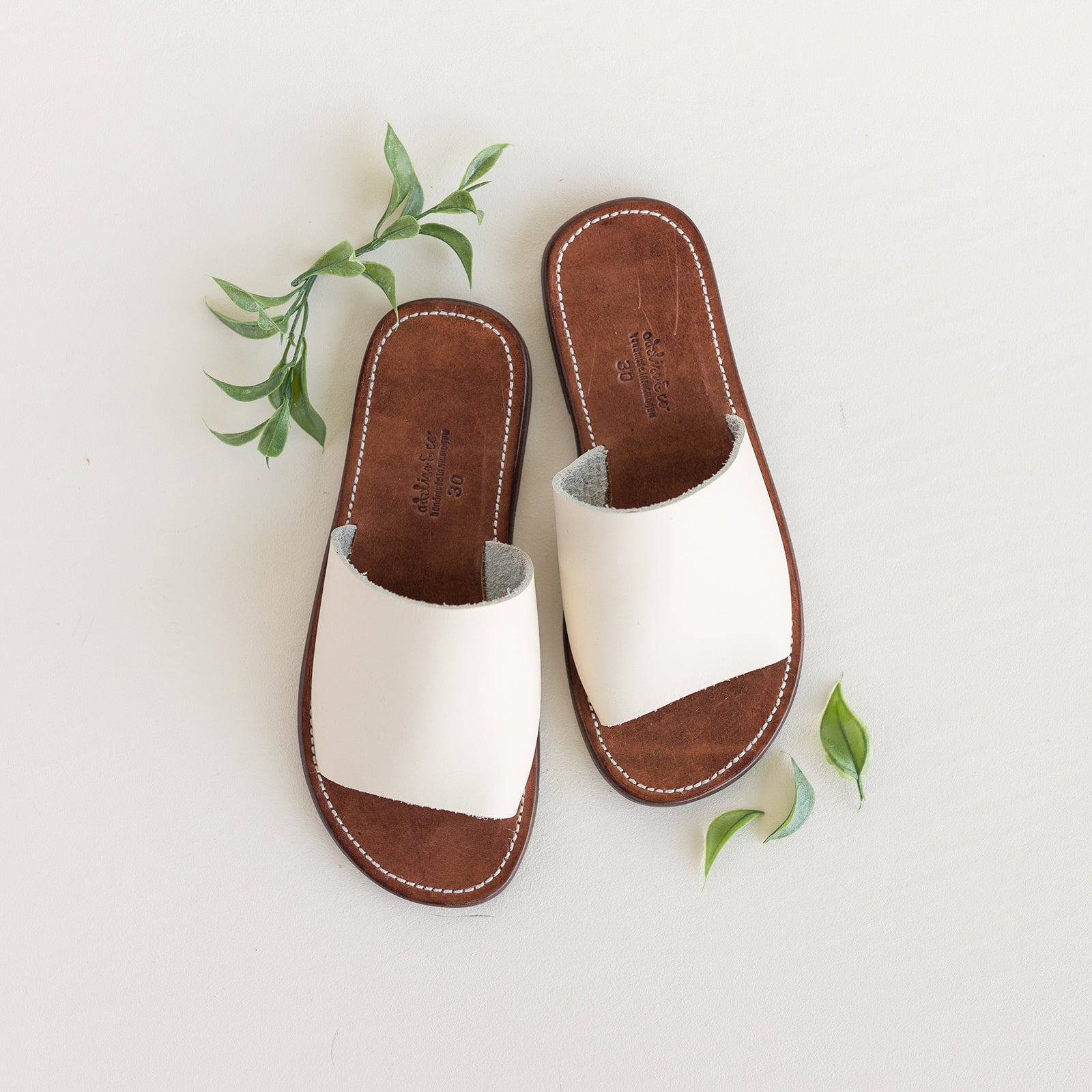 Open toe, slip on leather sandal for children in cream. 