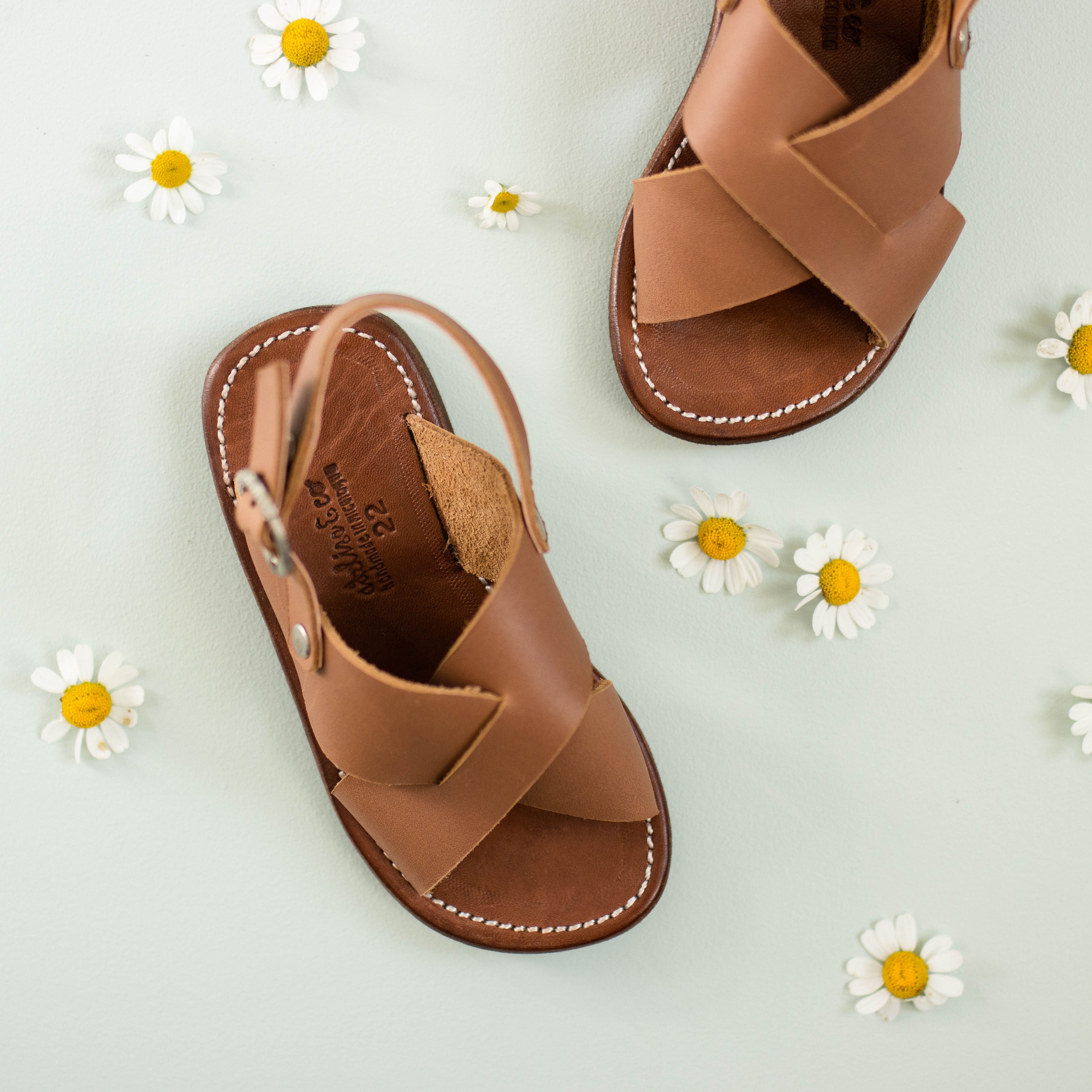 Cross strap, medium brown leather sandals for children. Unisex design.