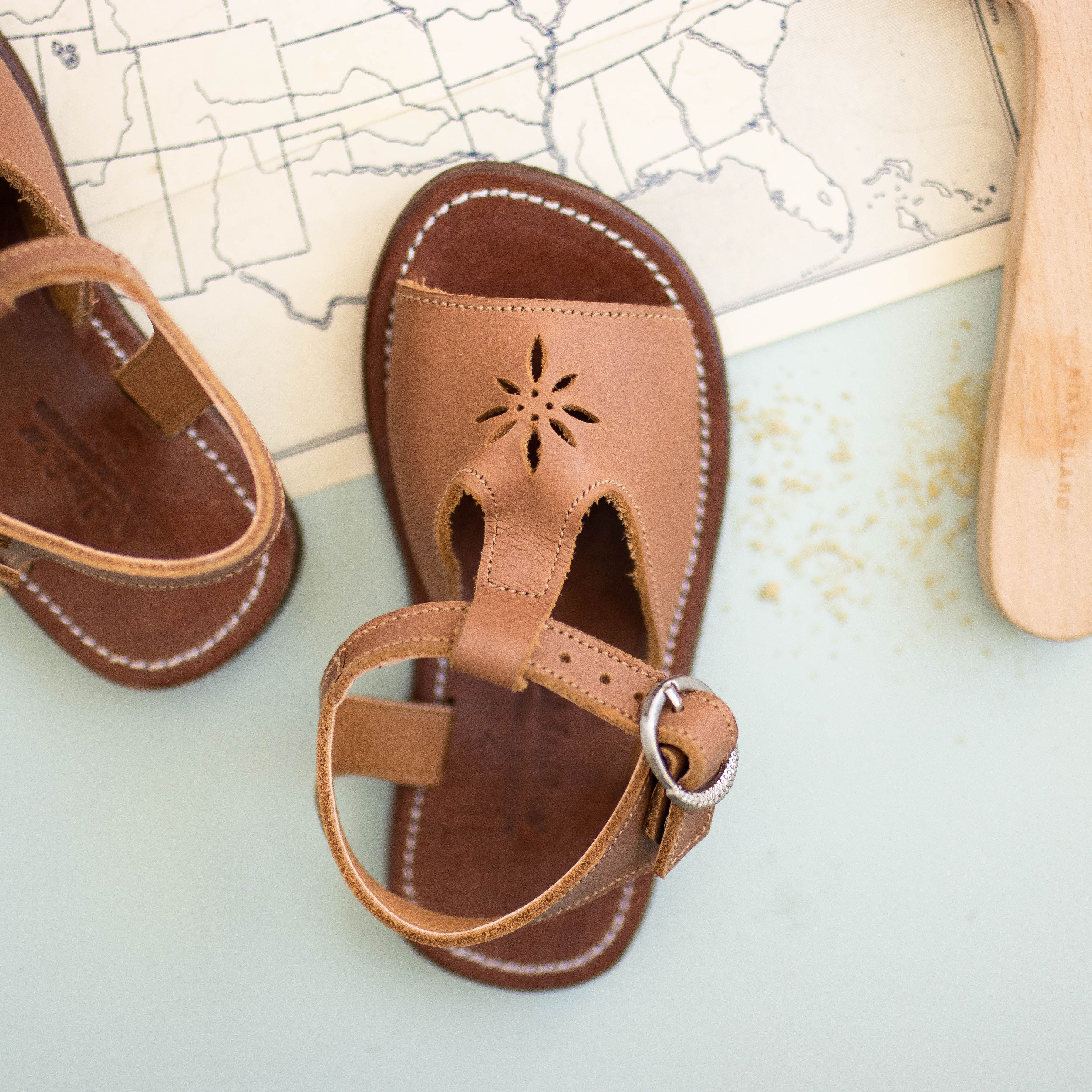 Adelisa &amp; Co t-bar leather sandals for girls with floral detailing.