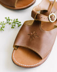T-bar leather sandals with floral detailing for women.