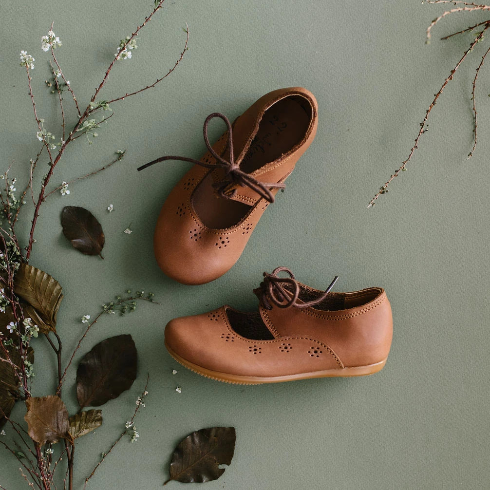 Adelisa & Co Sol Oxford style Mary Janes with sun details  in medium brown leather. These vintage style Mary Jane leather shoes for girls feature a subtle design that pairs well with any outfit.