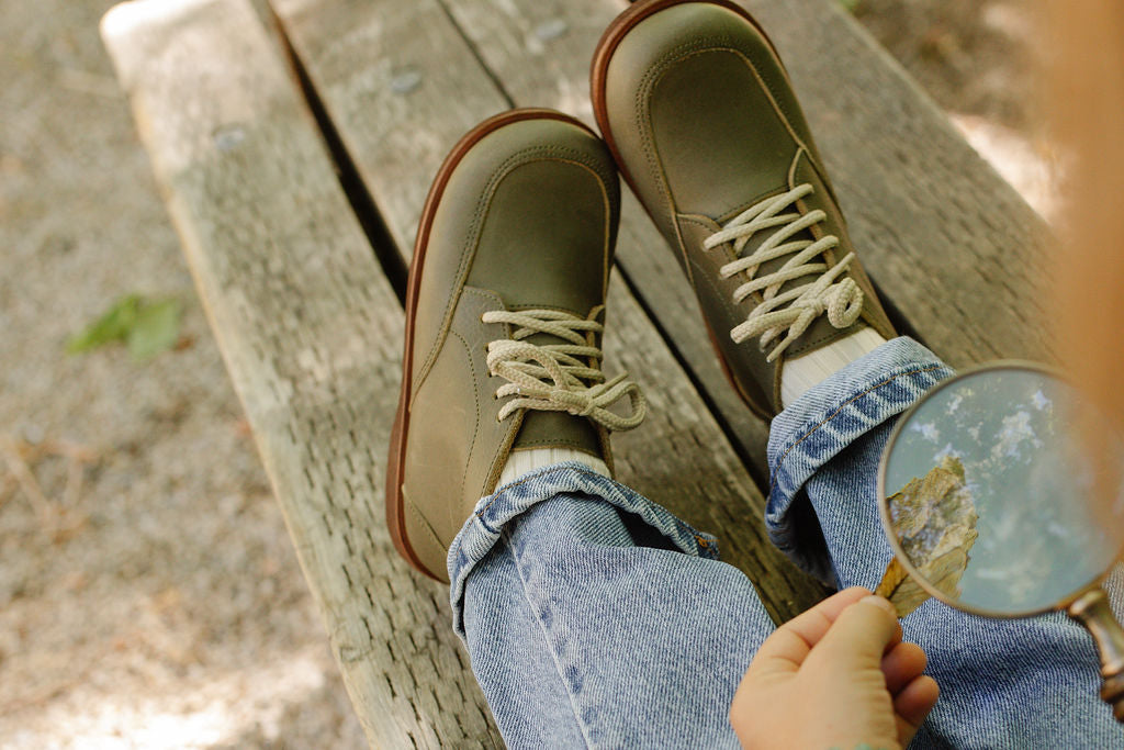 Vintage style, unisex leather boot for children that features a simple design and rounded toe. 