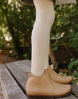 Handmade leather boots for girls in a beautiful beige leather. These boots feature a side zipper and a delicate floral trellis detail up the side of the boot.