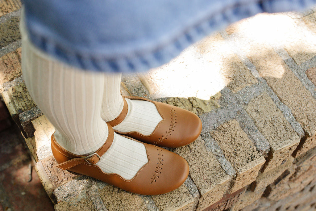 Adelisa &amp; Co&#39;s handmade leather Cosecha Mary Janes for babies, kids and youth. These vintage style mary janes are crafted by artisans in Nicaragua and feature soft brown leather with a delicate leaf detail.