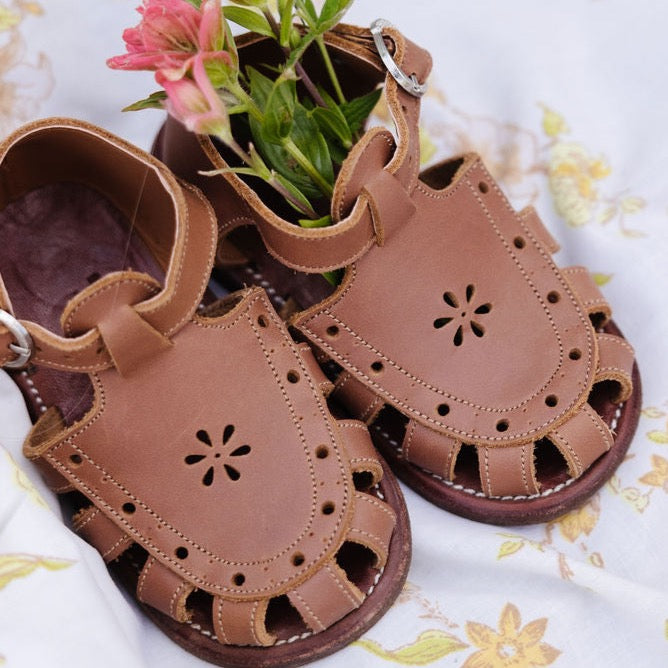 Adelisa &amp; Co medium brown leather sandals for girls with floral detailing.
