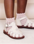 Closed toe, cream leather sandals for girls with floral detailing.