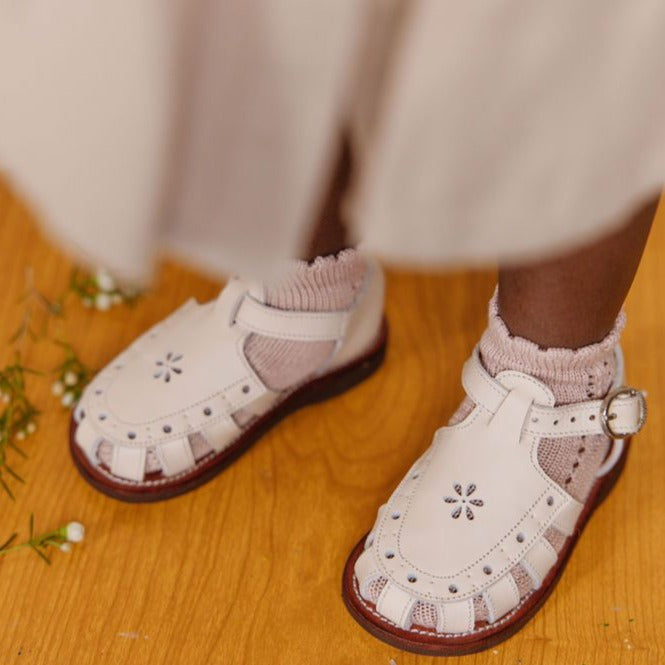 Closed toe, vintage style cream leather sandals for girls with floral detailing.