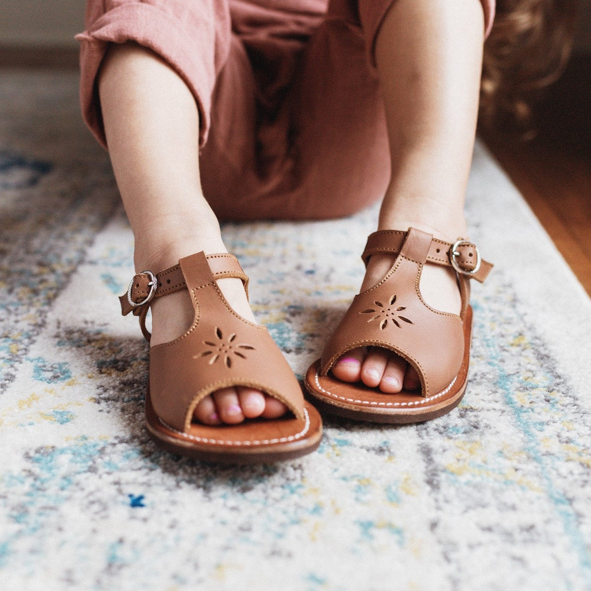 Adelisa &amp; Co t-bar leather sandals for girls with floral detailing.
