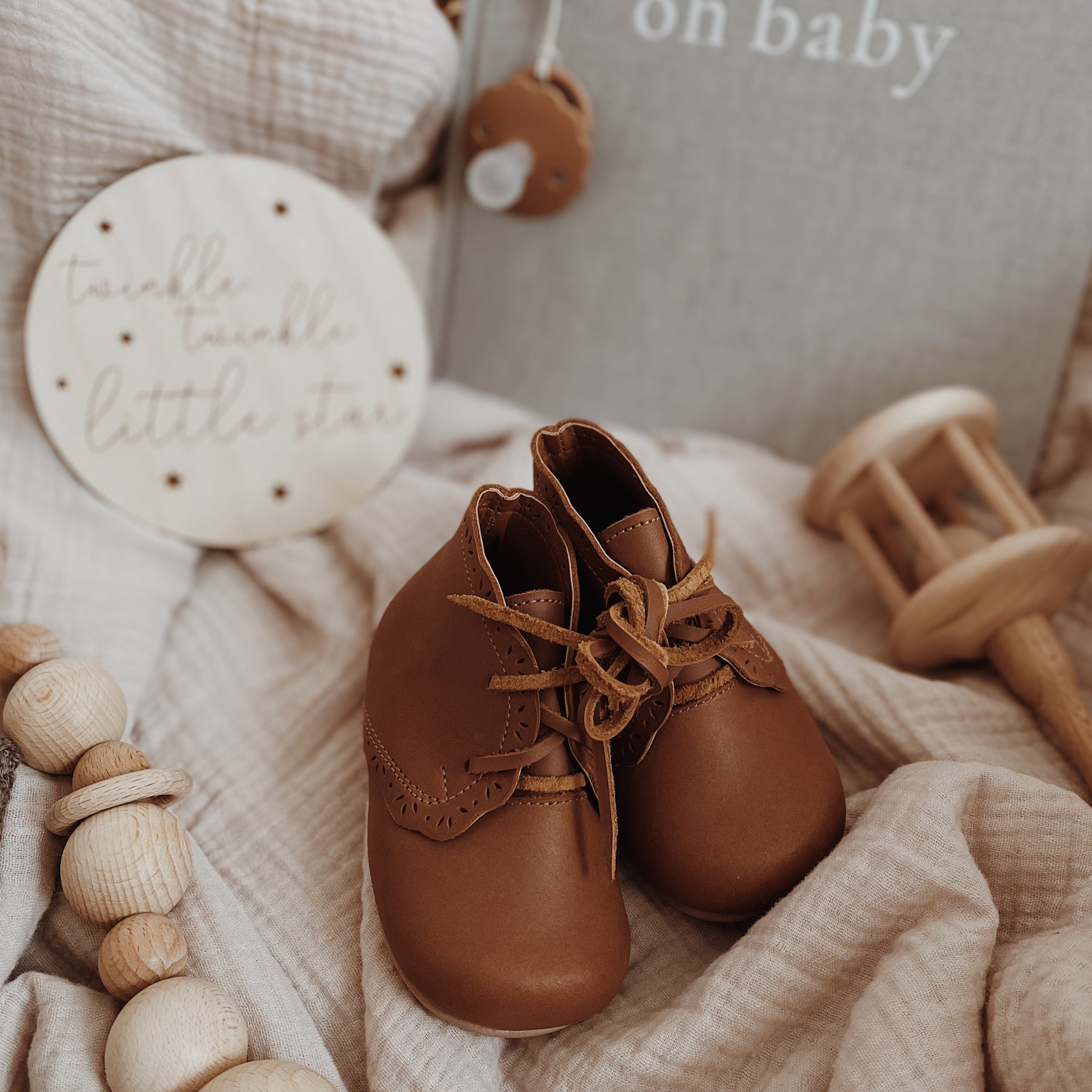 Soft sole, brown leather baby shoe with floral detailing