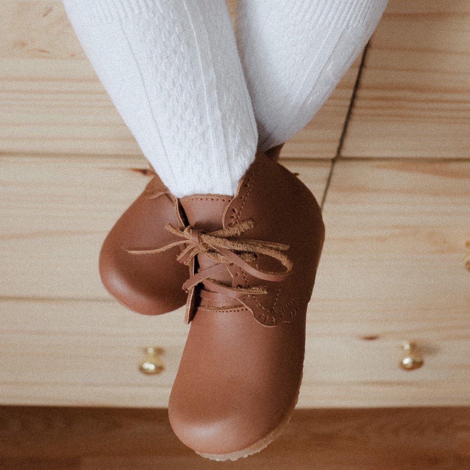 Adelisa &amp; Co handmade leather Primavera boots in a medium brown tone. These leather children&#39;s boots feature beautiful scallop edging and subtle floral details.